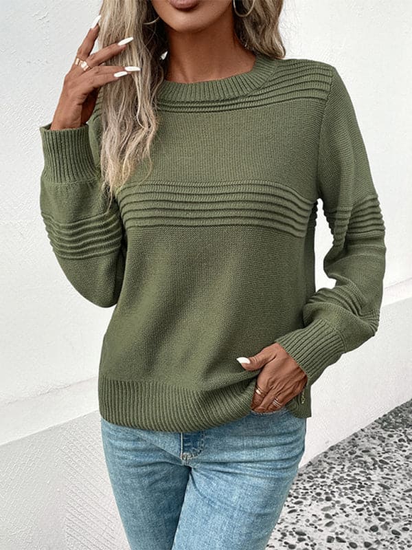 a woman in a green sweater smoking a cigarette